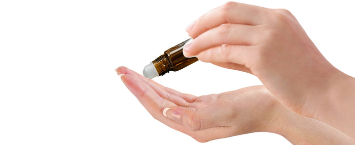 Step 1: Apply Divine Cardinal chamomile teething roll-on to clean fingers for natural baby gum relief